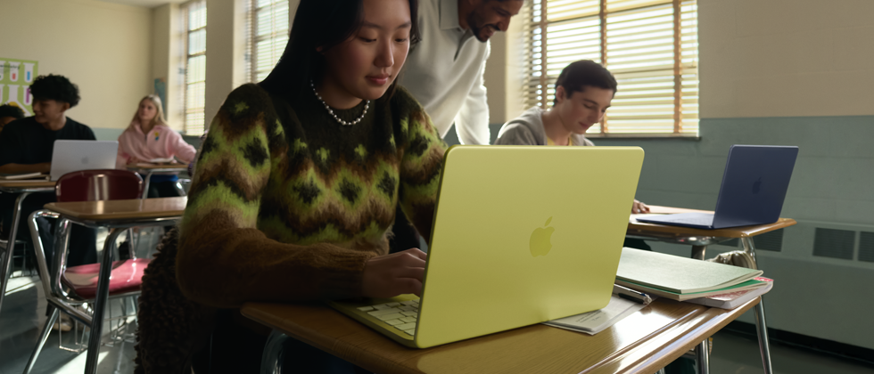 A student uses MacBook Neo, citrus color, unplugged in a classroom setting
